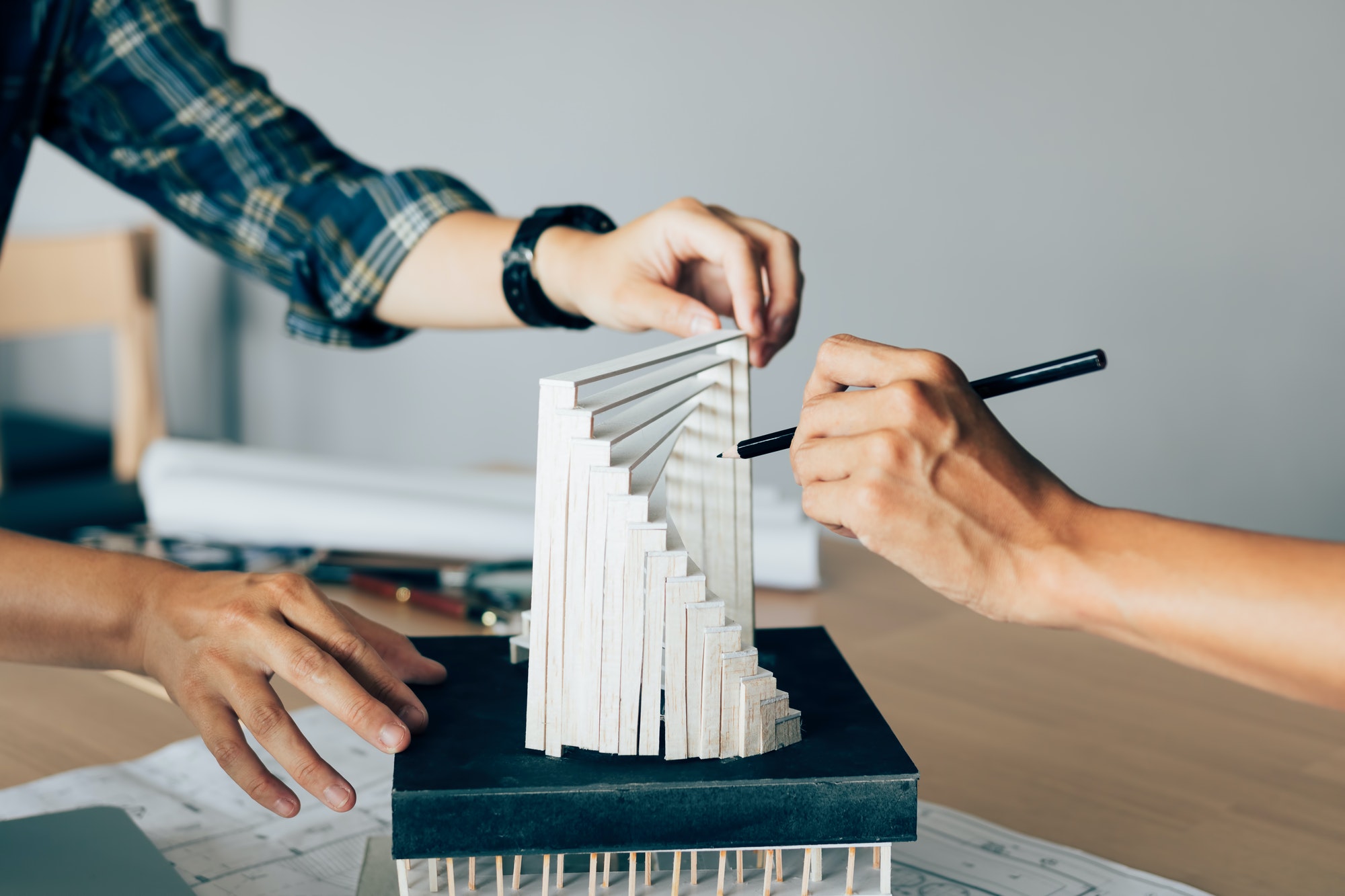 Architect reviewing architectural model in the office.