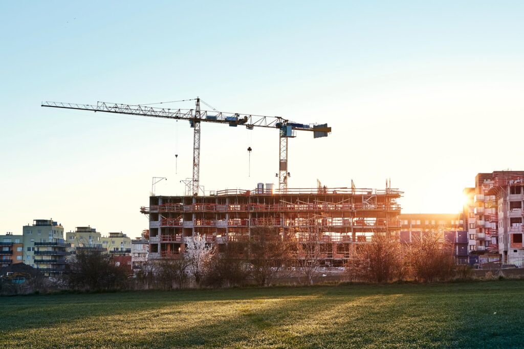 Construction site with cranes at the amazing sunrise. Construction of the new residential building.